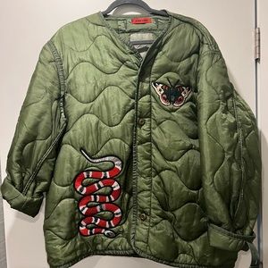 vintage army surplus jacket. With embroidered patches seen on front and back